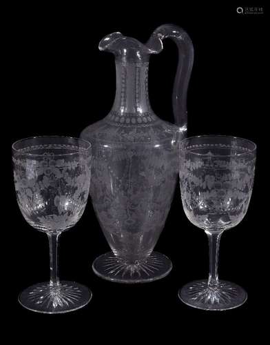 A Stourbridge engraved claret jug and two goblets ensuite