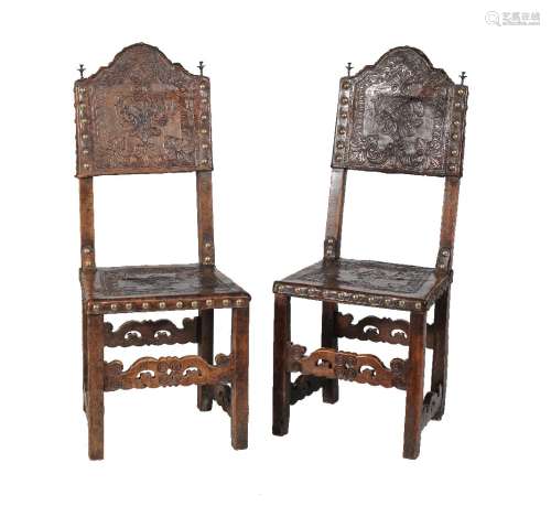 A pair of Spanish walnut and embossed leather side chairs