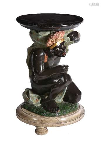 A low torchere or occasional table in the form of a blackamoor