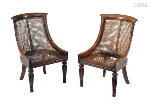 A pair of Regency mahogany bergere library chairs