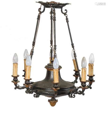A parcel gilt and patinated metal eight light chandelier in Louis Philippe taste