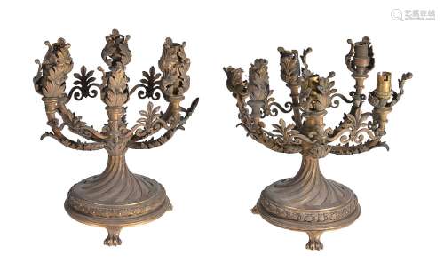 A pair of gilt and patinated metal six light table candelabra