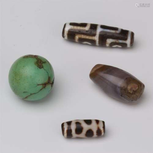 FOUR TURQUOISE DZI BEADS