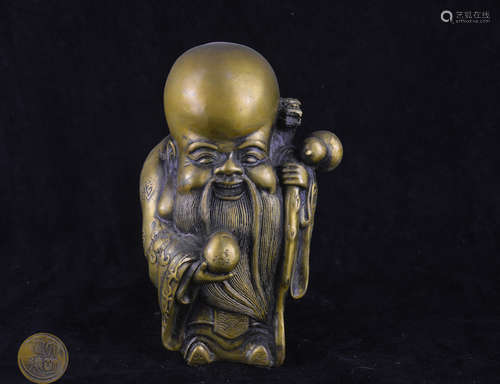 A BRONZE MOLDED SHOU FIGURE STATUE