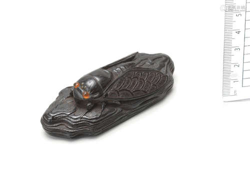 By Kanman, Iwami Province, early 19th century An ebony netsuke of a cicada