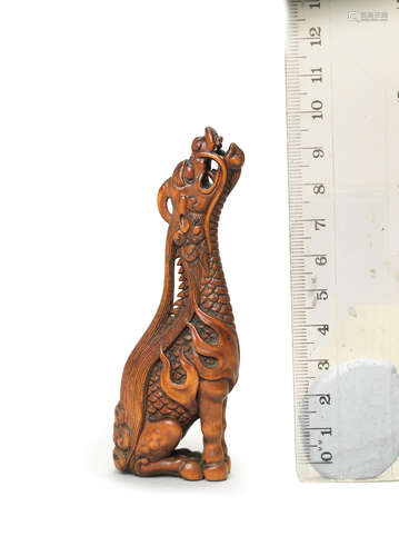 After Tomotada, Kyoto, 19th century A wood netsuke of a kirin