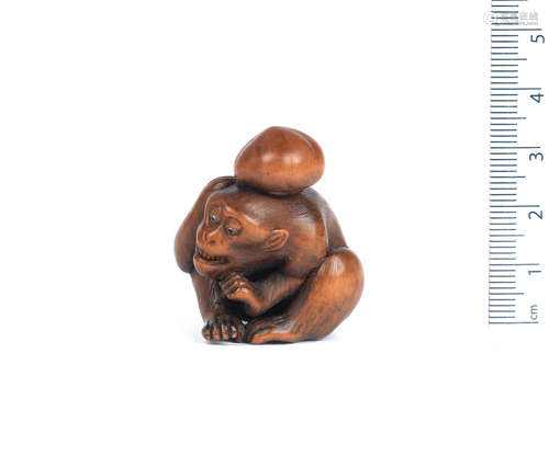 By Gyokusen Tomochika, Kyoto, 19th century  A wood netsuke of a monkey