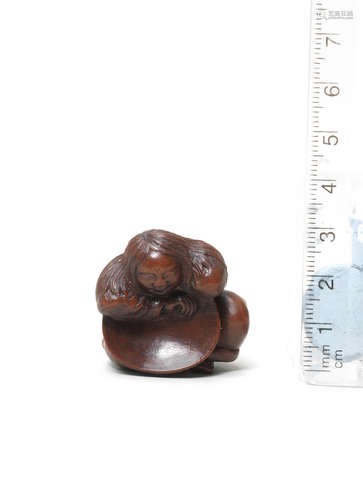 By Tomin, Tsu, 19th century A small wood netsuke of a shojo