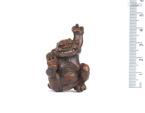 School of Kano Tomokazu, Gifu, 19th century A wood netsuke of an oni