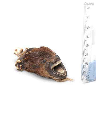 Late 19th century A stag antler netsuke of a makatsugyo (dragon-fish)