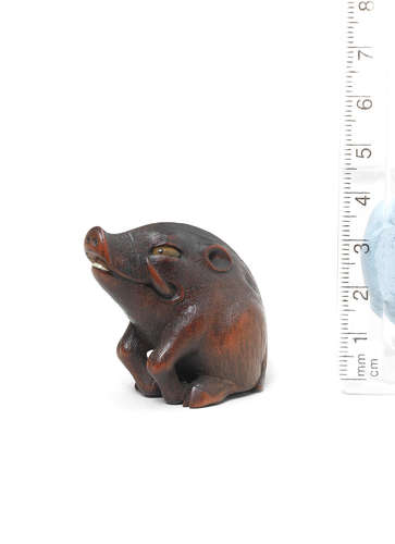 By Sari, Iwashiro Province, 19th century A wood netsuke of a wild boar