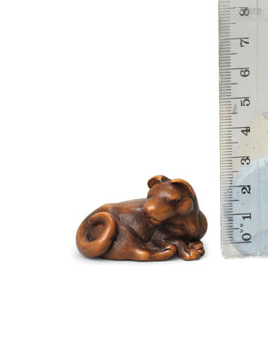 By Masanao, Kyoto, late 18th century A wood netsuke of a recumbent dog