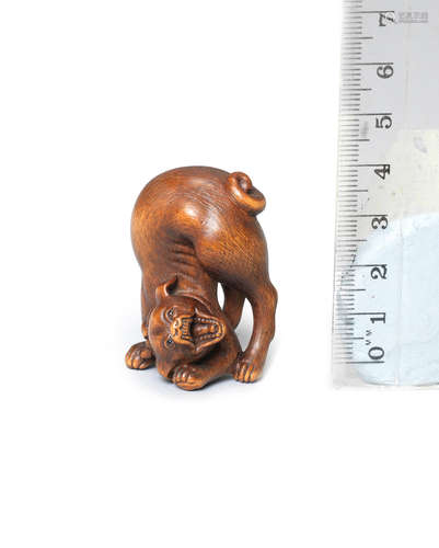 By Hidemasa, Osaka, 19th century A wood netsuke of a dog