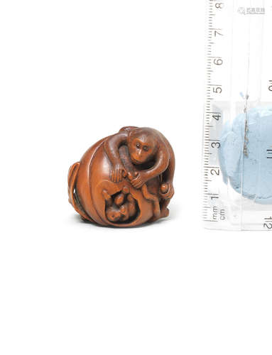 After Kano Tomokazu, Gifu, 19th century A wood netsuke of a monkey on a peach