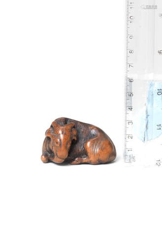 Early 19th century A wood netsuke of a recumbent goat