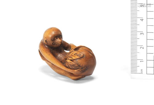 Early 19th century A wood netsuke of a monkey