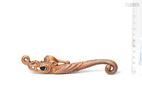 Early 19th century A wood sashi netsuke of a flying dragon