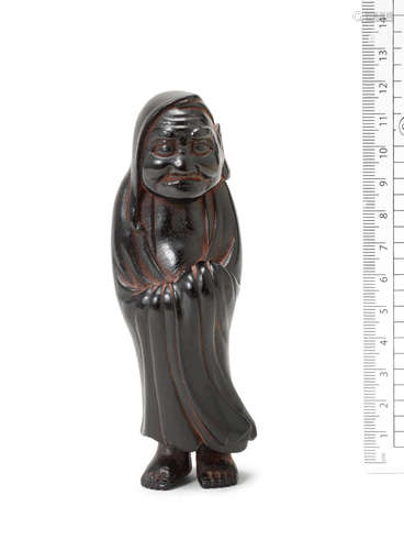 Late 18th/early 19th century A large wood netsuke of Daruma