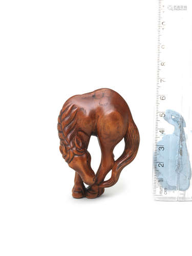 Early 19th century A boxwood netsuke of a grazing horse