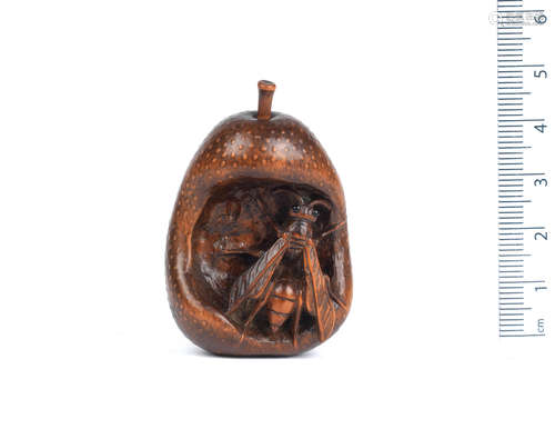 By Gekko, Edo, 19th century A wood netsuke of a wasp in a pear