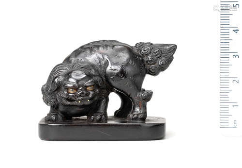 19th century An ebony seal netsuke of a shishi