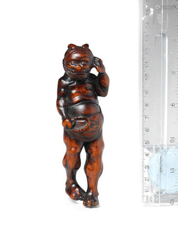 18th century A large wood netsuke of an oni