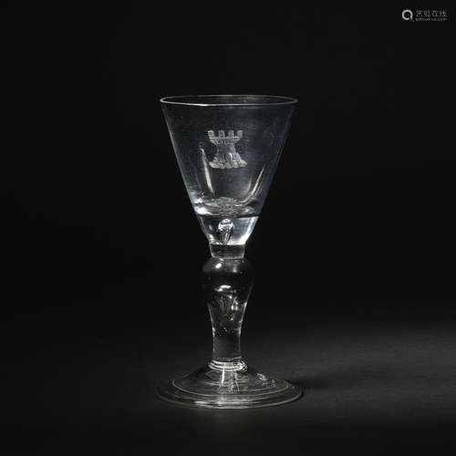 An armorial baluster wine glass, circa 1720