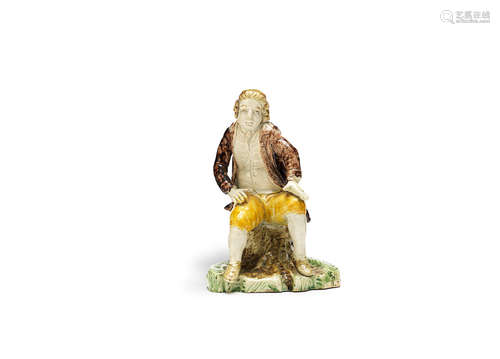 A Staffordshire pearlware figure of a seated gentleman, probably John Wilkes, circa 1780-90