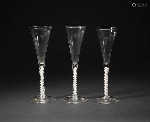 A set of three opaque-twist wine flutes, mid 18th century