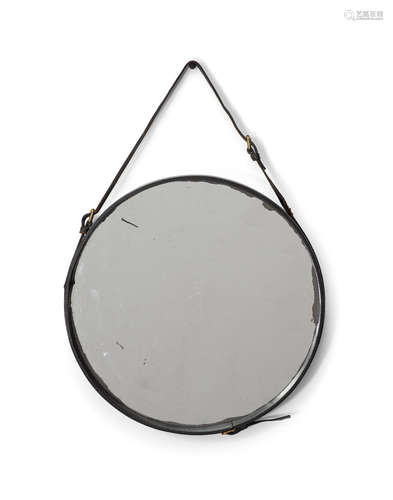 Mirrorcirca 1950for Hermès, leather, brass, glassdiameter 18in (45cm); length 25in (64cm)  Jacques Adnet (1901-1984)