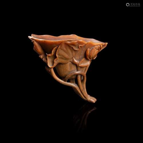 Y RARE WELL-CARVED RHINOCEROS HORN 'LOTUS' LIBATION CUP QING DYNASTY, 17TH CENTURY 17.3cm high