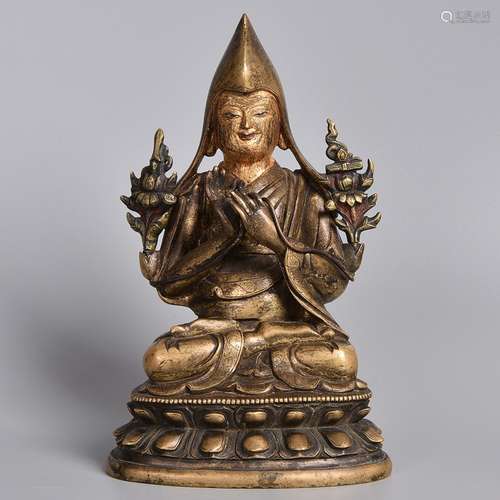 A GILT-BRONZE FIGURE OF LAMA