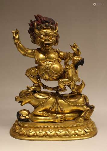 A GILT-BRONZE FIGURE OF DAMCHEN GARWA NAGPO