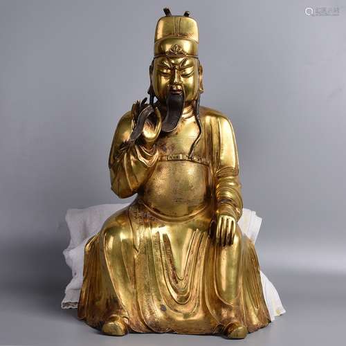 A GILT-BRONZE FIGURE OF JAMBHALA