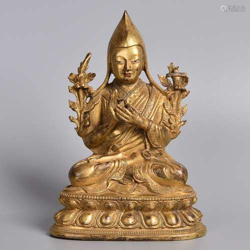 A GILT-BRONZE FIGURE OF LAMA