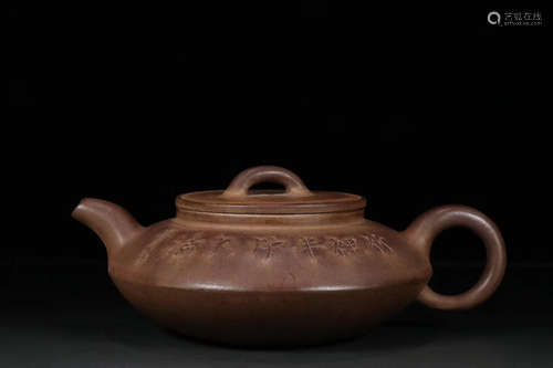 A PURPLE CLAY TEAPOT