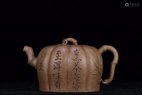 A DUAN MUD TEAPOT WITH POEM CARVING ON BODY