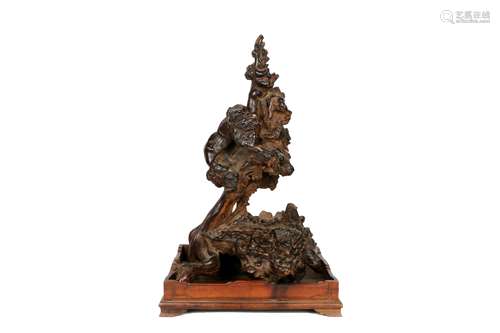 A Chinese Carved Chenxiang Wood Decoration with Rose Wood Base