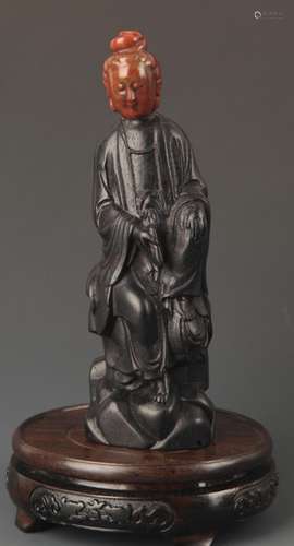 AN EBONY WOOD WITH SOAPSTONE GUAN YIN STATUE