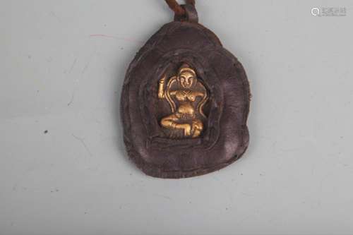 A COWHIDE WITH BRONZE TIBETAN BUDDHISM PENDANT