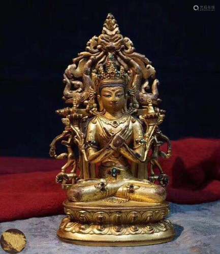 A GILT BRONZE MOLDED TIBETAN BUDDHA STATUE