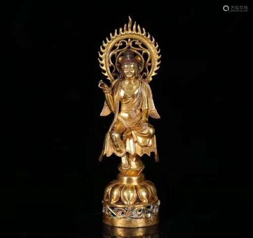 A GILT BRONZE MOLDED STANDING BUDDHA STATUE