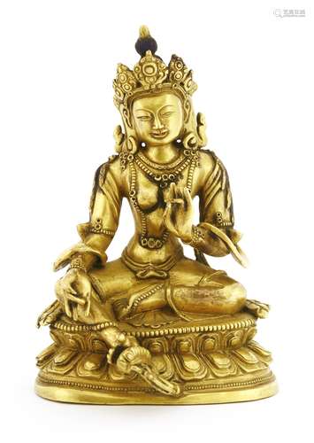 A Chinese gilt bronze bodhisattva, seated in Lalitasana pose on a double lotus base with her right ...