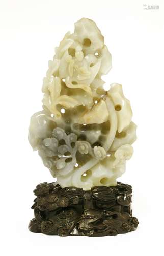 A Chinese jade carving, 19th-20th century, of an immortal riding a crane flying amongst rocks with ...