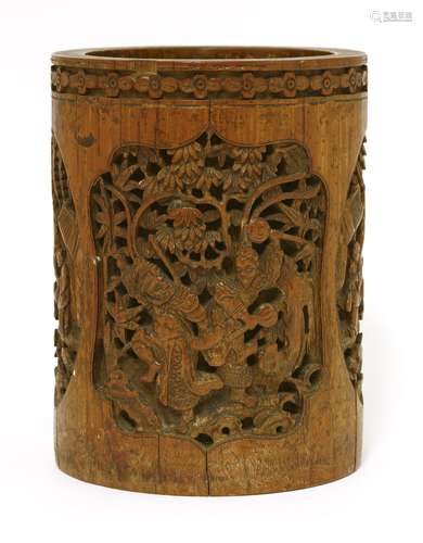 A Chinese bamboo brush pot, late 19th century, deeply carved with figures in a garden or on ...