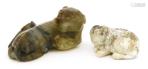 A Chinese jade carving, of a recumbent Buddhist lion with two pups alongside, 11cm long, and ...