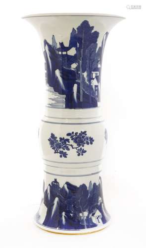 A Chinese blue and white beaker vase, probably Kangxi, painted with a man fishing from a boat on a ...