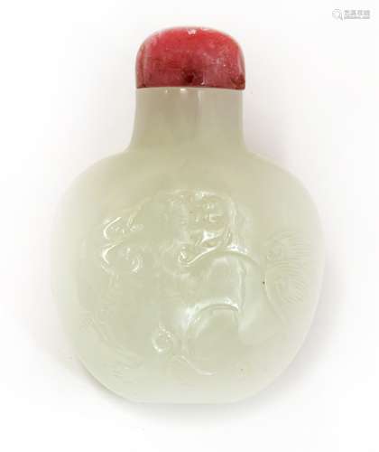 A Chinese jade snuff bottle, Qing dynasty (1644-1911), incised with a Buddhist lion to each side, ...