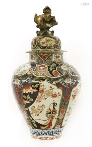 A large Japanese Arita Imari jar and cover. c.1720, of baluster shape, painted in iron-red gilt, ...