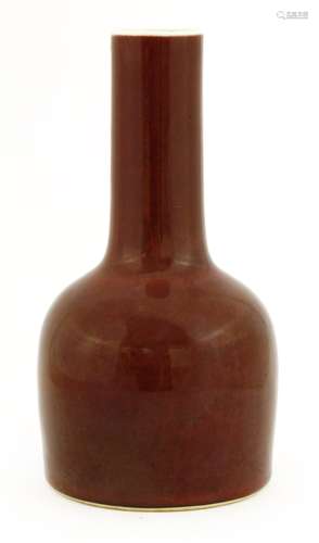 A Chinese red-glazed vase, Republic period (1912-1949), in the Kangxi style, of bell shape with a ...